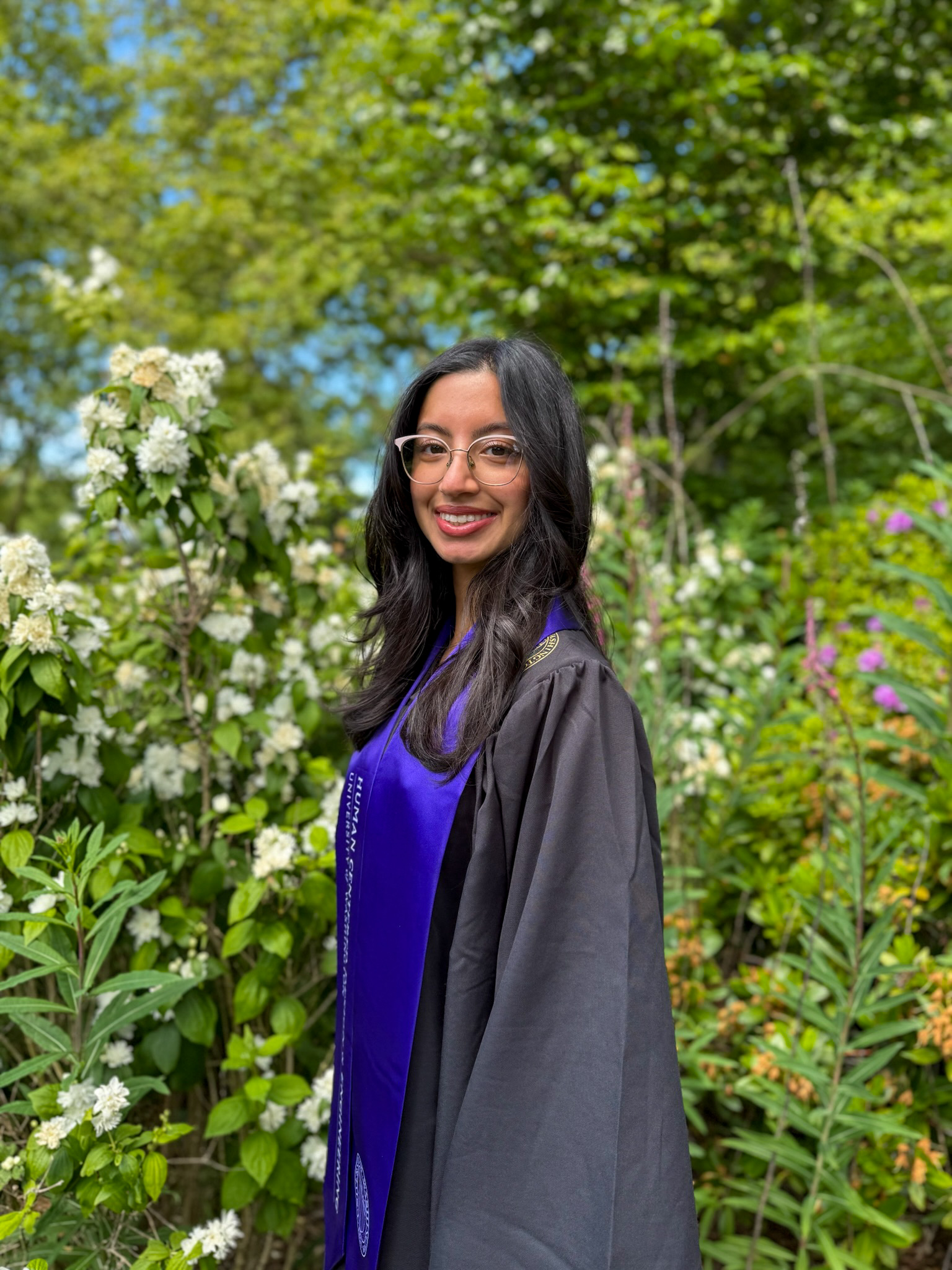 Sehrish Daud in graduation regalia with an HCDE stole