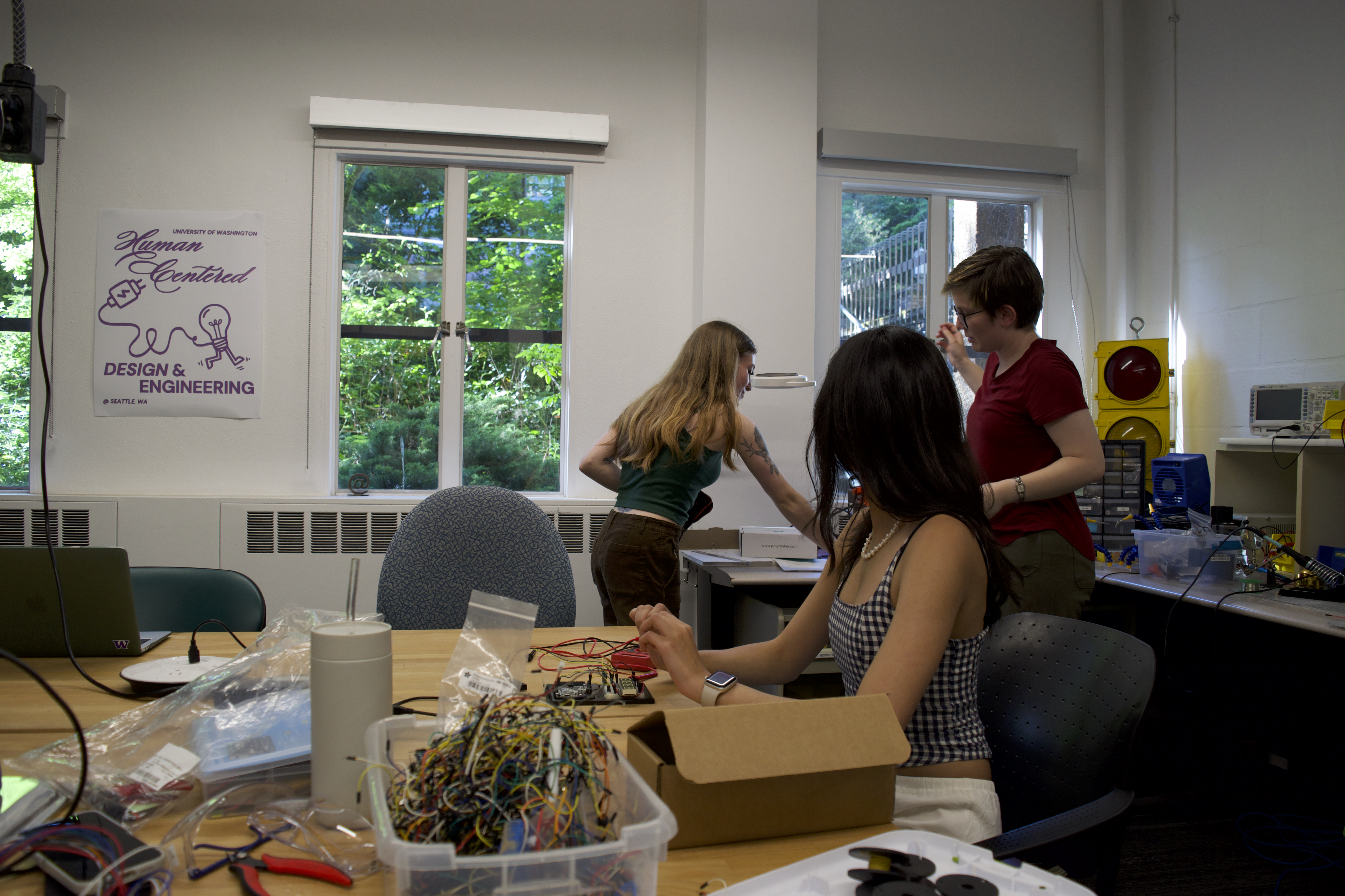 Students working in the HCDE MakeLab — electronics, tools, and prototyping equipment at Sieg Hall
